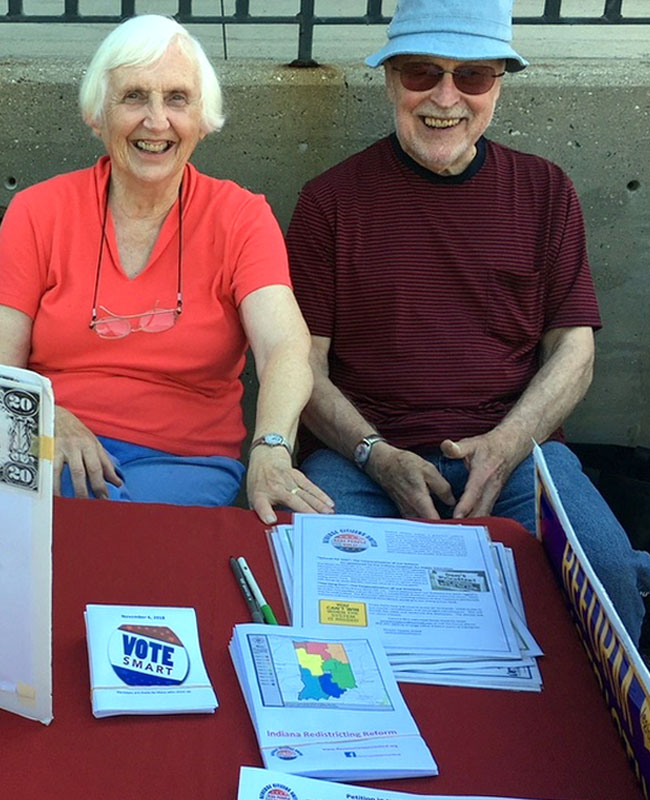 Tomilea and Jim Allison tabling at the Bloomington Farmers Market.