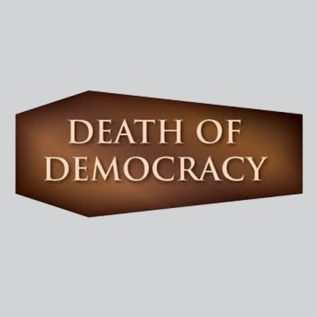 The term "death of democracy" graphically depicted inside a coffin