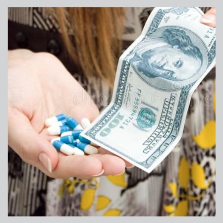 a woman holds medicine and a $100 dollar bill